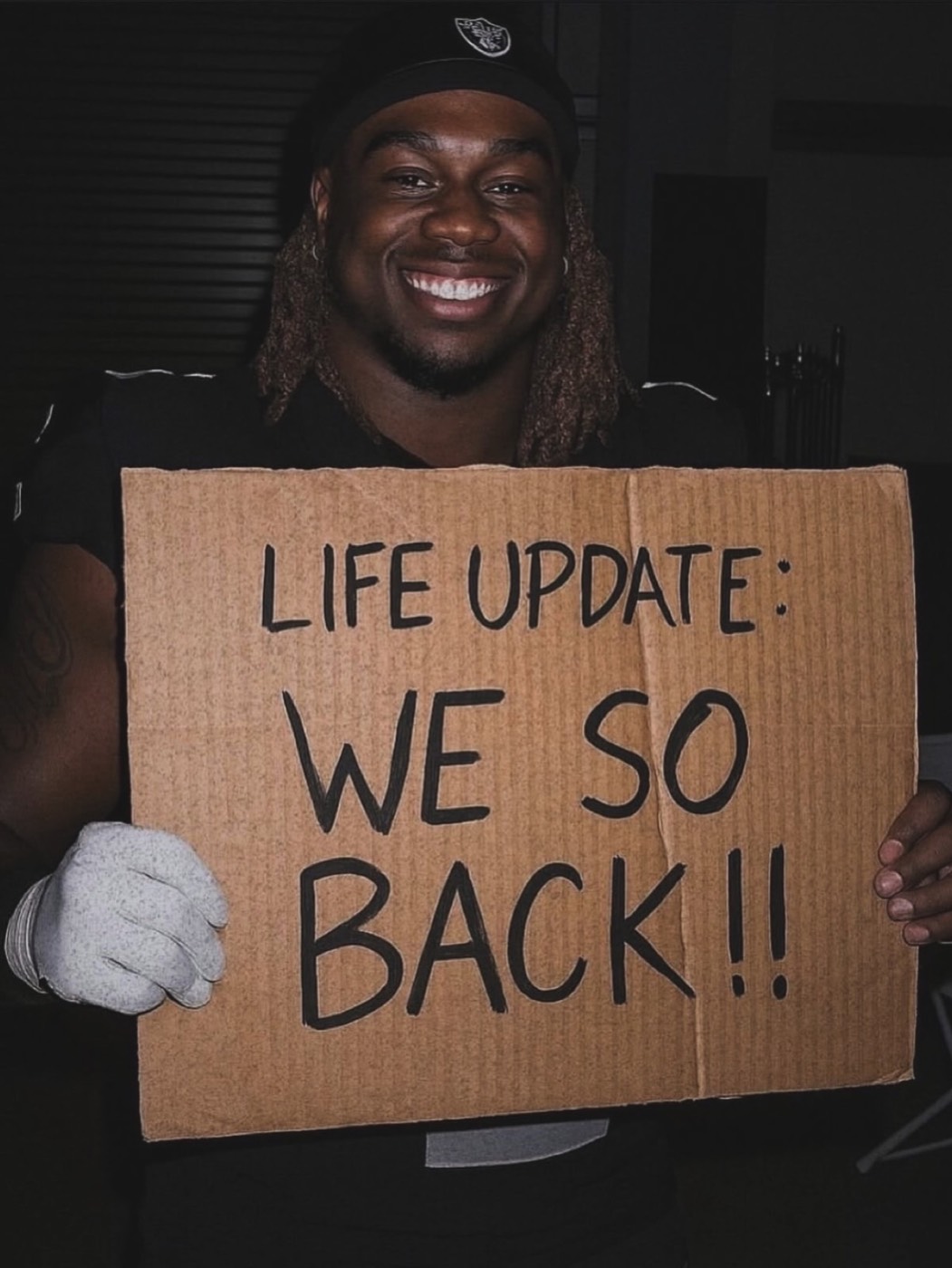Zion Fajemilugba holding a personal life update sign